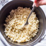 Brown rice in a Dutch oven just cooked fluffed with a fork.