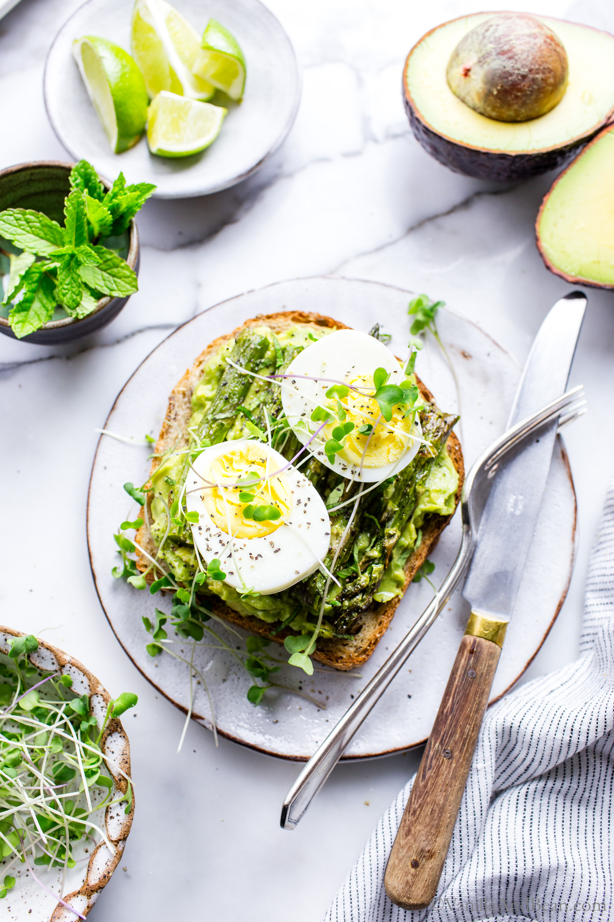 Avocado toast with hard cooked steamed eggs on the toast.