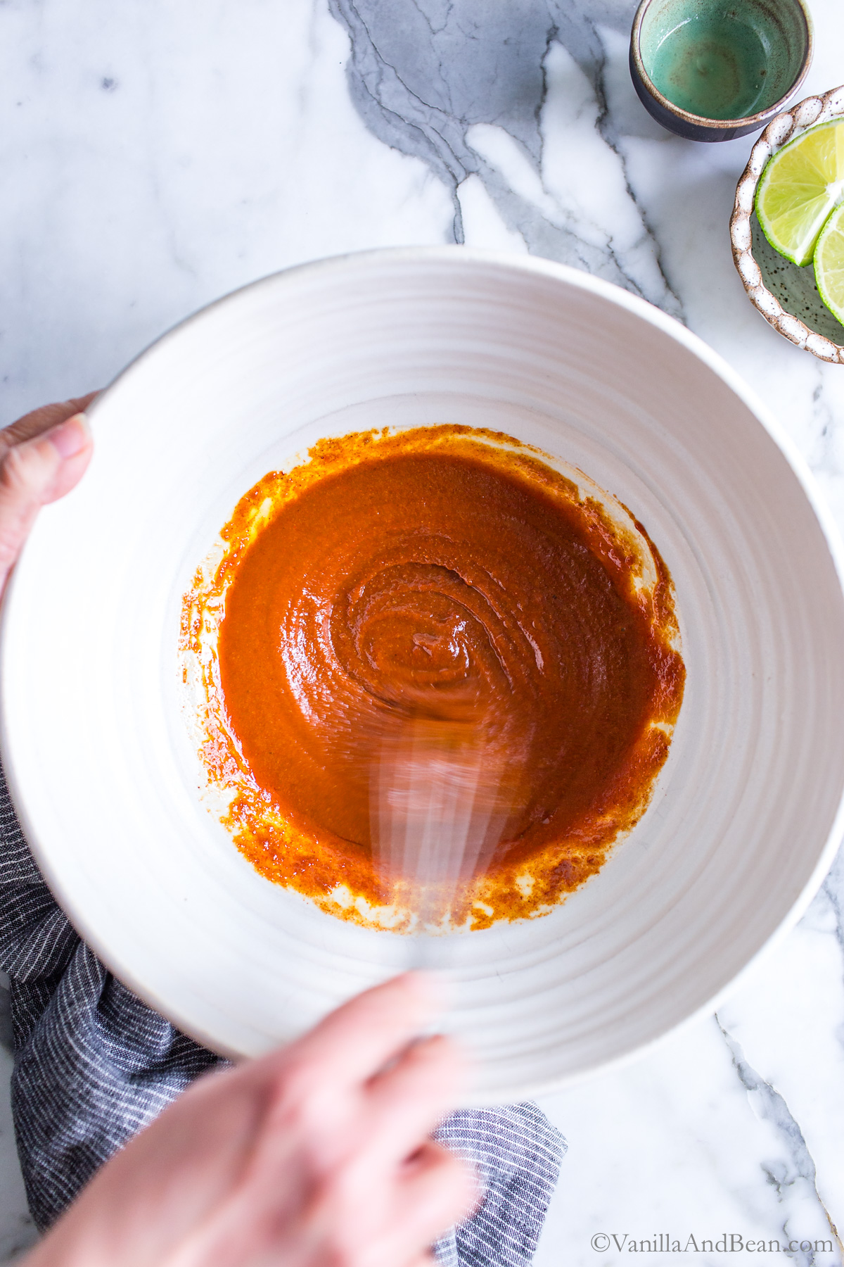Whisking seasonings in a bowl.