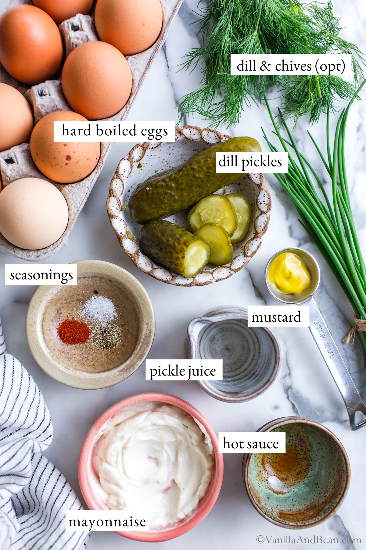 Labeled Ingredients for Dill Pickle Deviled Eggs on a tabled.