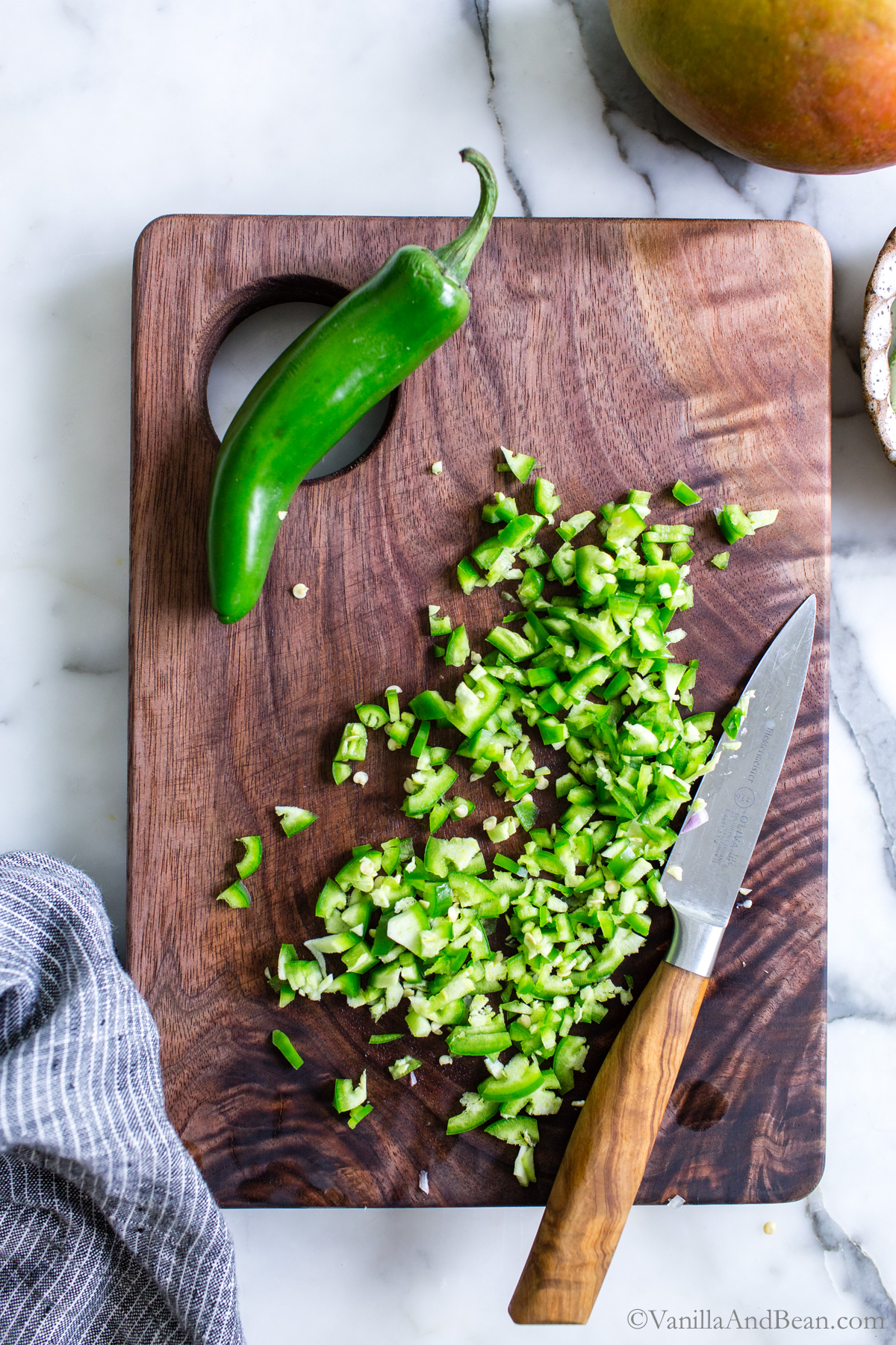 Diced Serrano peppers on a cutting board.