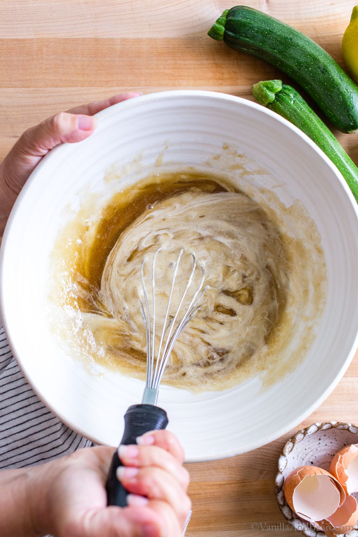 Mixing sourdough discard into the wet ingredients in a bowl.