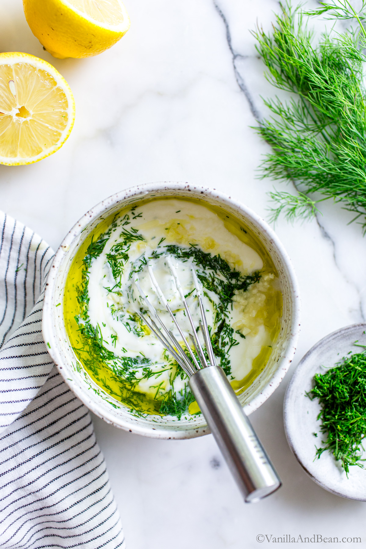 Whisking yogurt Dill Sauce in a bowl.