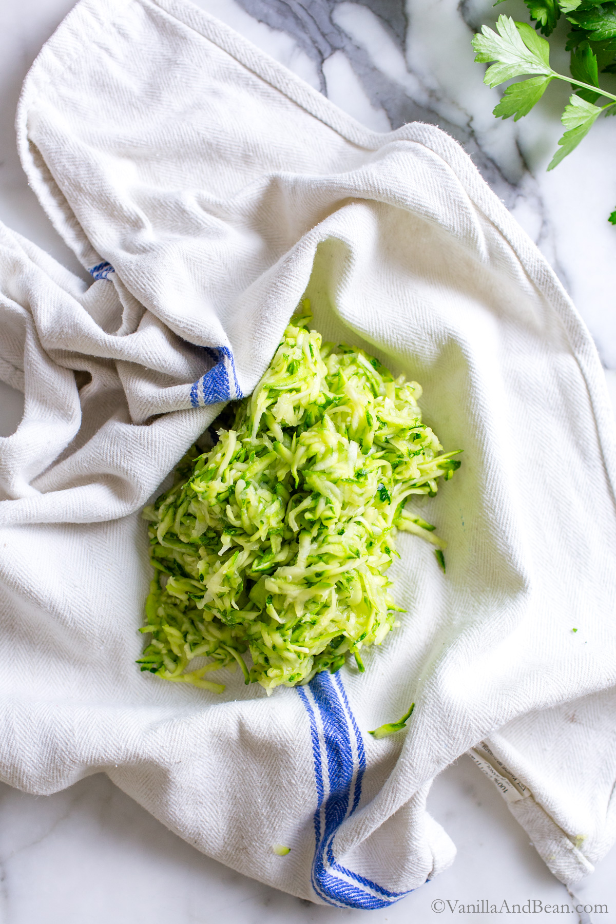 Shredded zucchini on a tea towel.