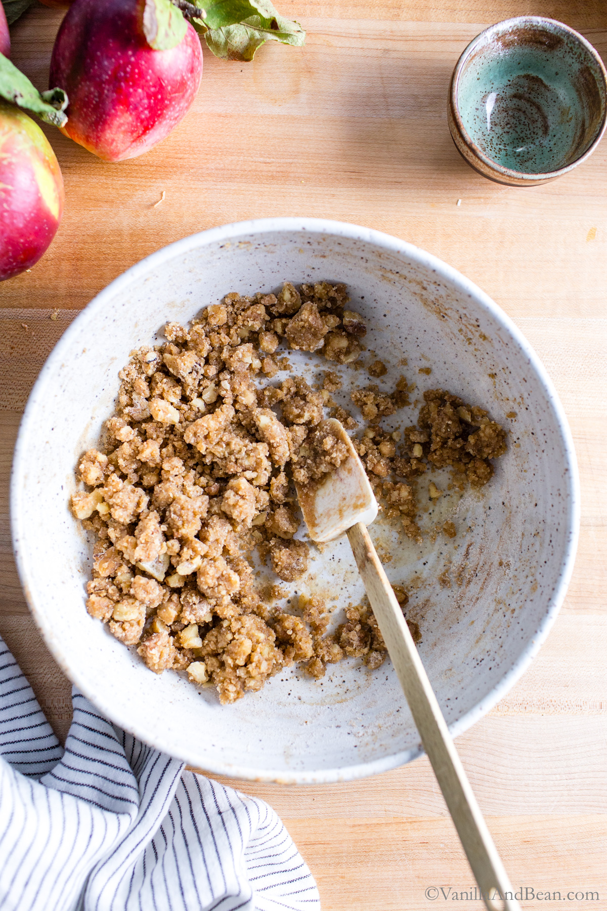 Crumble topping in a bowl with a spatula.