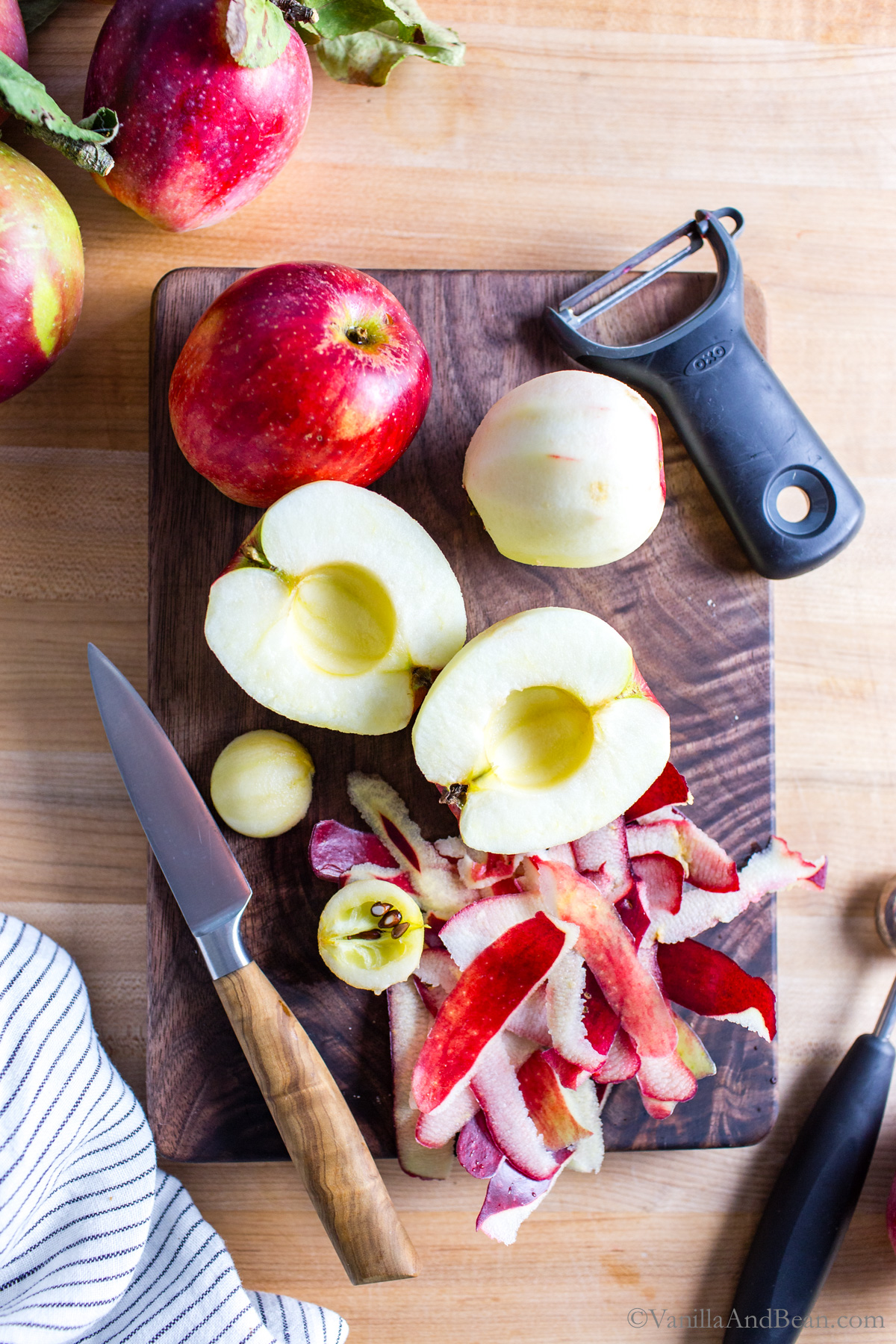 Sliced and cored apples on a cutting board.