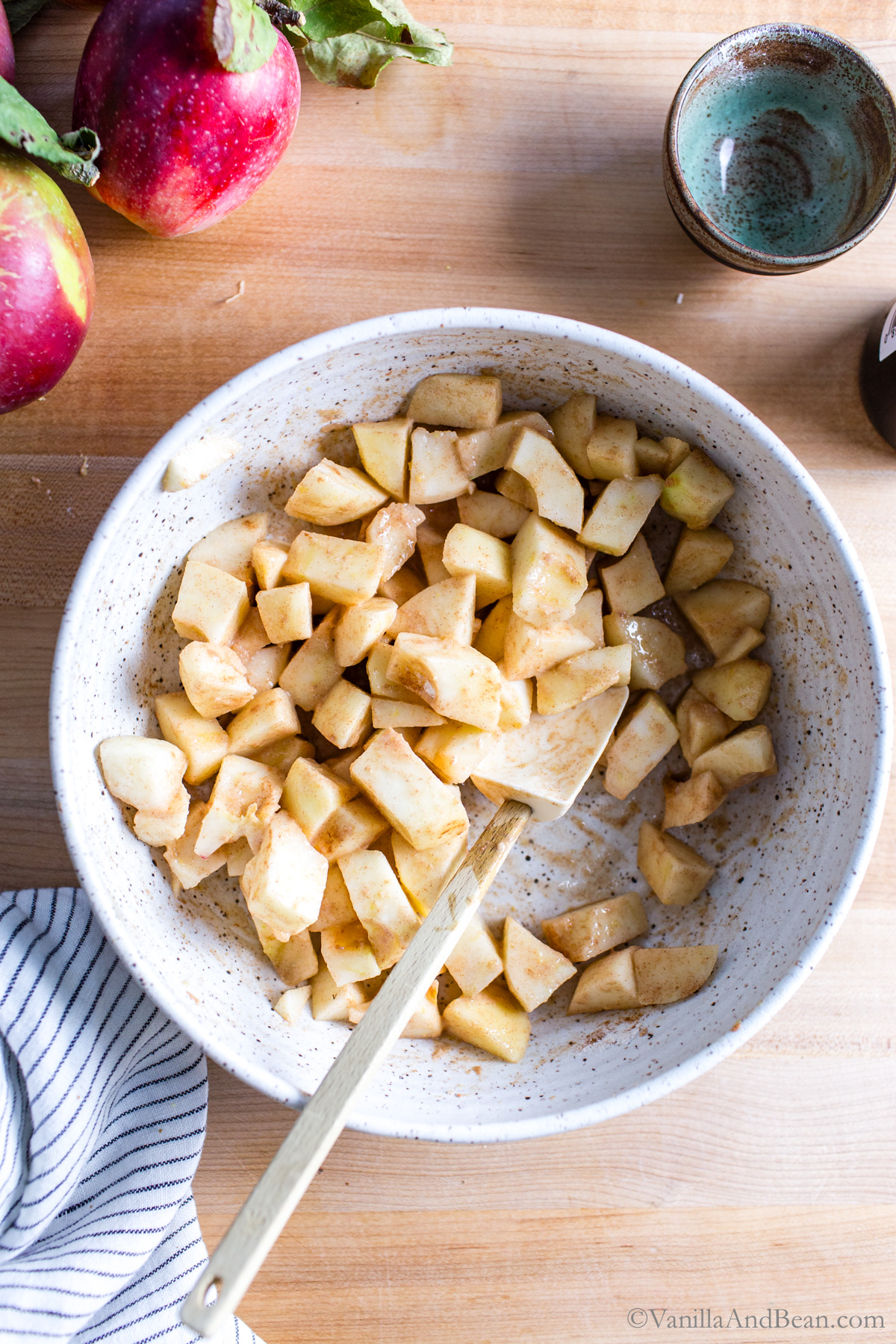 Stirred spiced diced apples in a bowl.